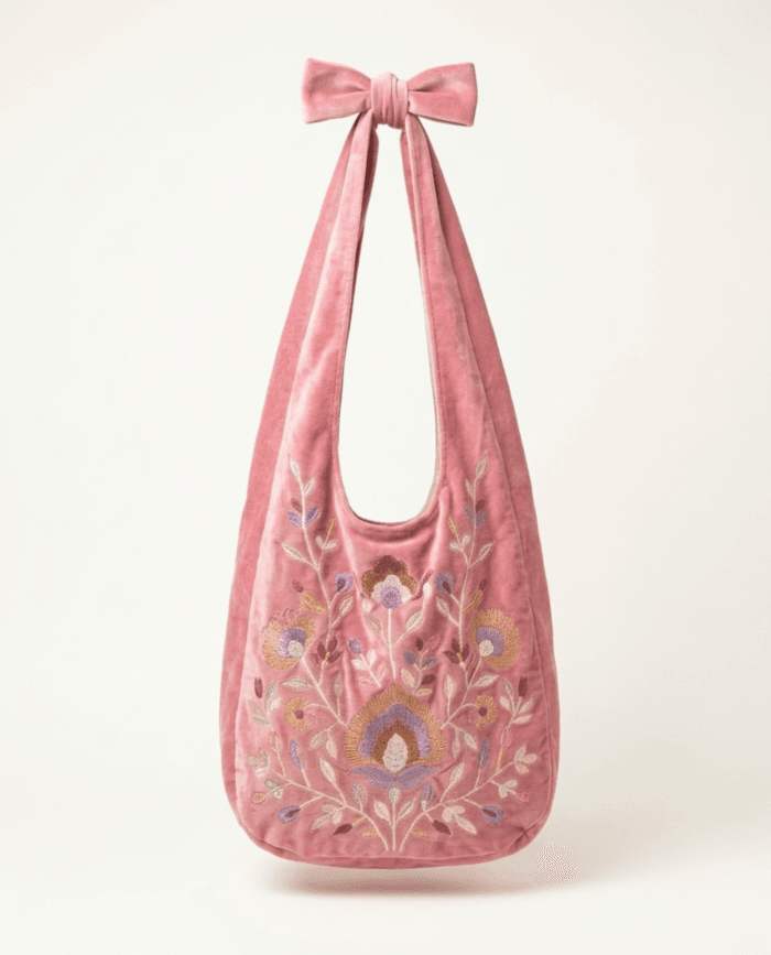 Pink embroidered velvet bag, front view on plain background with Rodia bloom embroidery